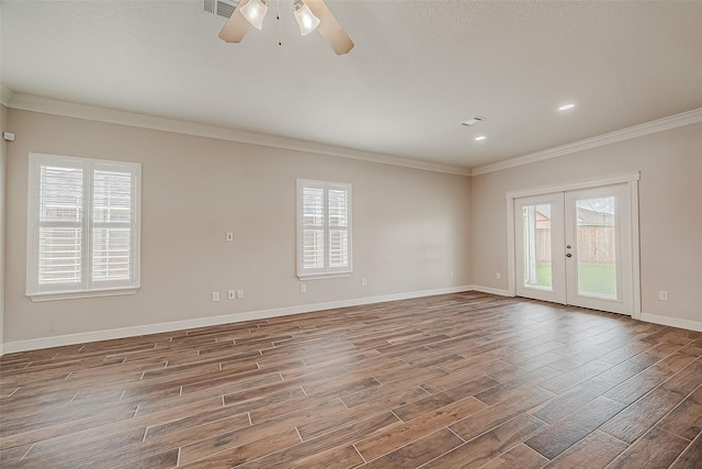 8705 Rowen Ct, Needville, TX 77461 - spare room featuring french doors, wood finished floors, and a healthy amount of sunlight