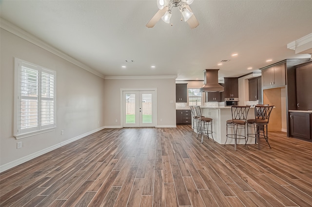 kitchen featuring custom range hood, a healthy amount of sunlight, and dark hardwood / wood-style floors