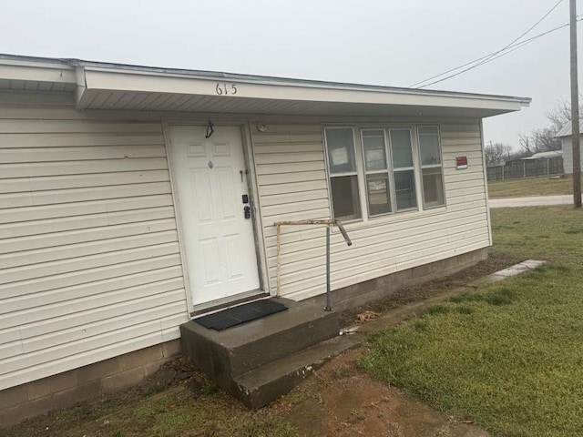 property entrance with a yard