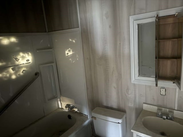 bathroom featuring vanity, toilet, and a bath