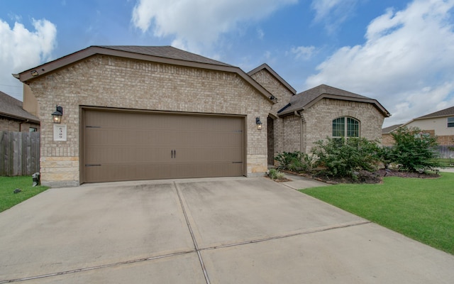 view of front of property featuring a front yard and a garage