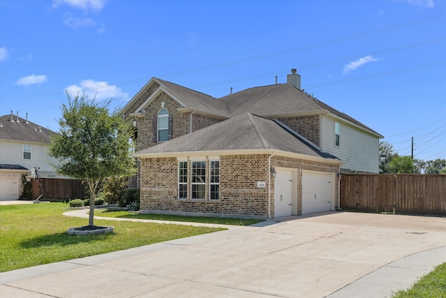 view of property with a front lawn and a garage