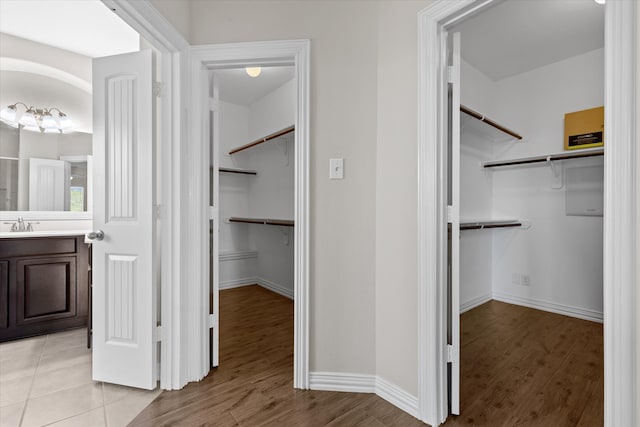 spacious closet featuring light hardwood / wood-style flooring