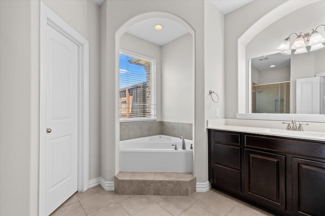 bathroom with vanity, plus walk in shower, and tile patterned flooring