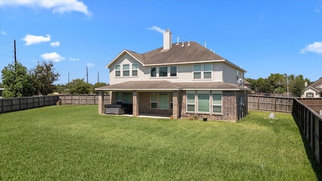 rear view of property featuring a yard