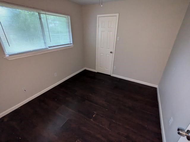 unfurnished room featuring dark hardwood / wood-style floors