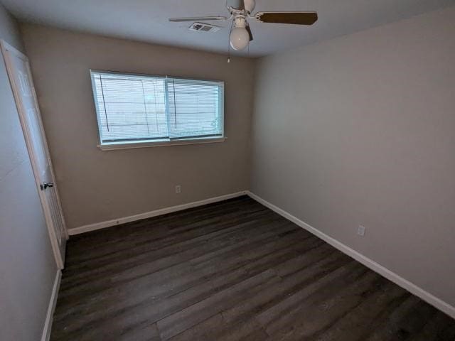 empty room featuring dark hardwood / wood-style floors and ceiling fan