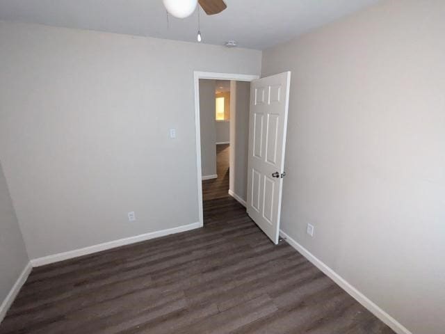 empty room featuring dark hardwood / wood-style floors and ceiling fan