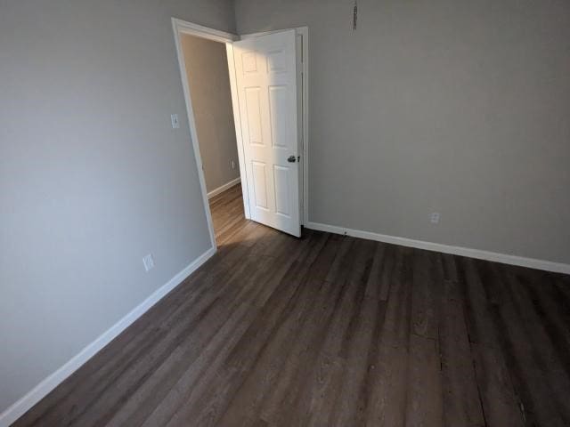 unfurnished room featuring dark hardwood / wood-style flooring