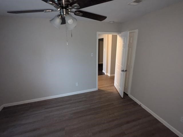 spare room featuring ceiling fan and dark hardwood / wood-style flooring