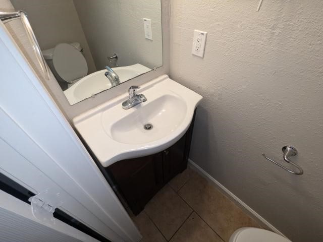 bathroom with tile patterned floors, toilet, and sink