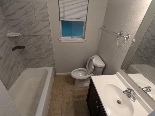 full bathroom with tile patterned floors, vanity, toilet, and tiled shower / bath