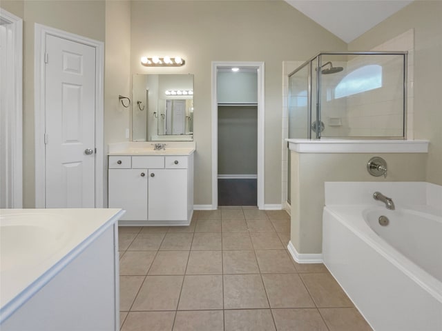 bathroom with lofted ceiling, vanity, tile patterned floors, and plus walk in shower