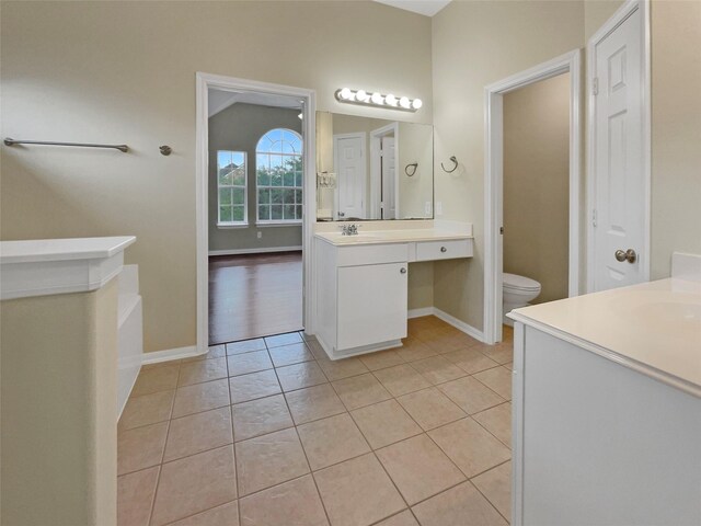 bathroom with tile patterned flooring, toilet, and vanity