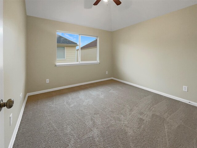 empty room with carpet flooring, ceiling fan, and vaulted ceiling