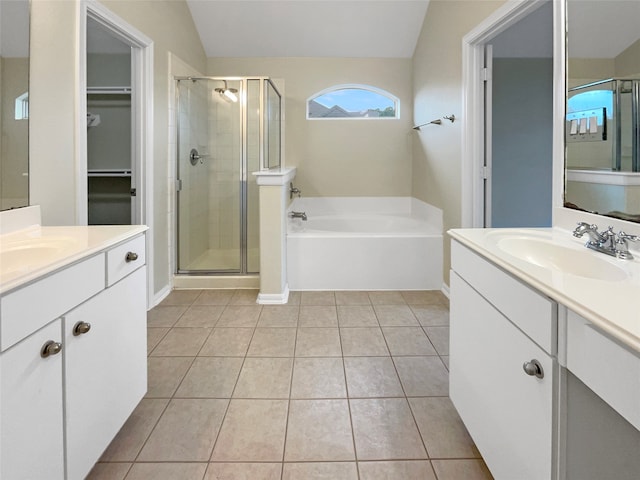 bathroom with tile patterned floors, separate shower and tub, vanity, and vaulted ceiling