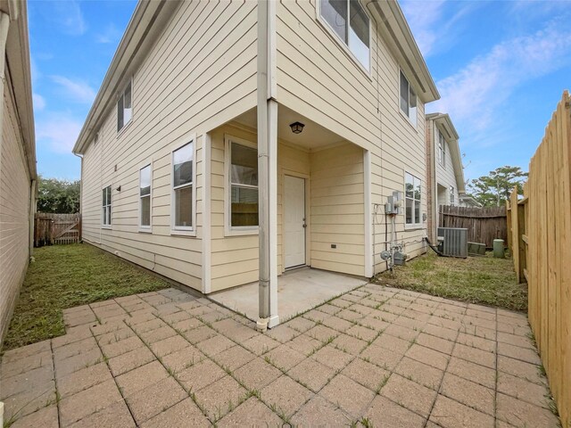 rear view of house with a patio and central AC