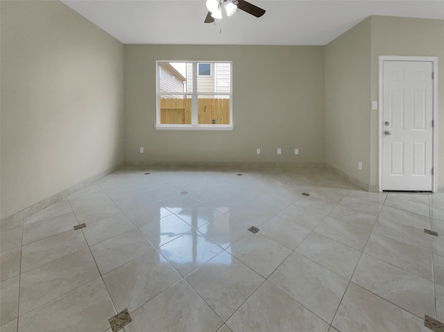 spare room featuring ceiling fan and light tile patterned floors