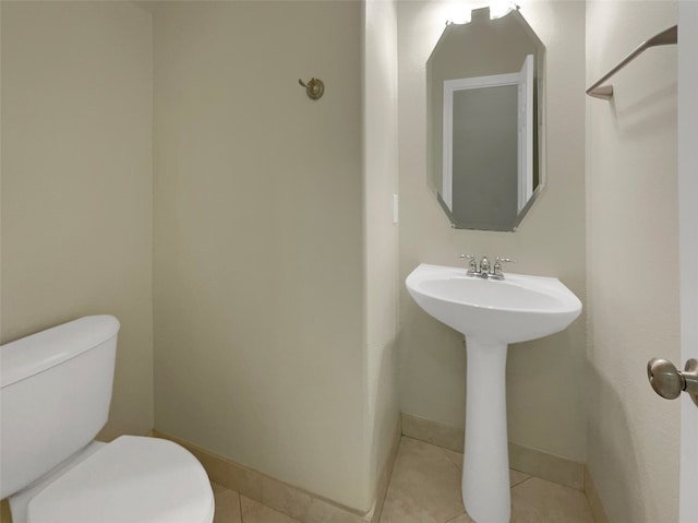 bathroom featuring toilet and tile patterned floors