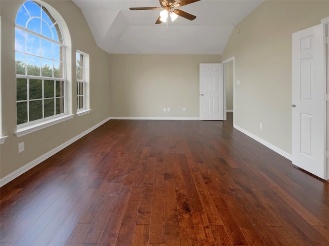 spare room with ceiling fan, dark hardwood / wood-style floors, and vaulted ceiling