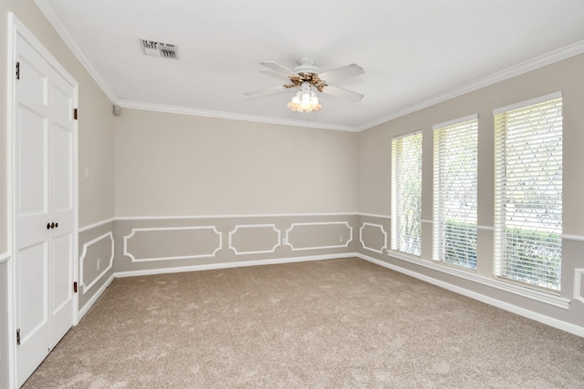 empty room featuring ceiling fan, light colored carpet, and ornamental molding