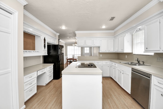 kitchen with black appliances, plenty of natural light, sink, and a kitchen island