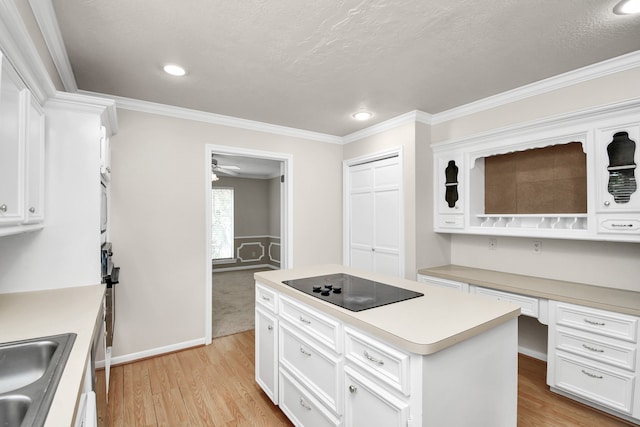 kitchen featuring black electric cooktop, a center island, white cabinets, light hardwood / wood-style flooring, and ornamental molding