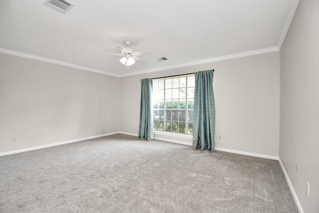 spare room featuring crown molding, ceiling fan, and carpet