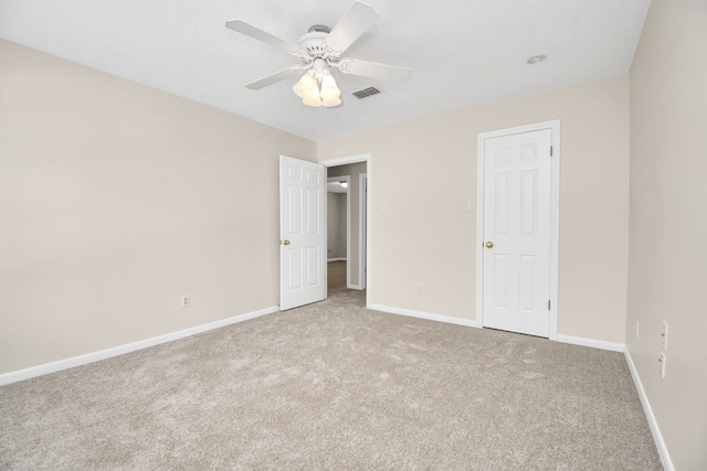 unfurnished bedroom featuring ceiling fan and light colored carpet