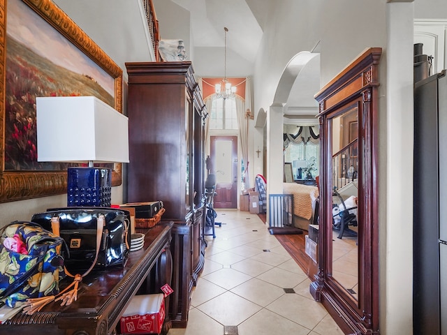 kitchen featuring a notable chandelier, high vaulted ceiling, decorative light fixtures, and light tile patterned flooring