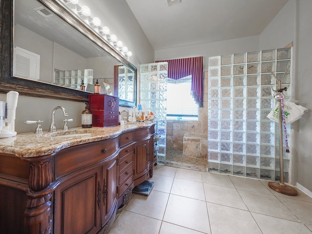 bathroom featuring vanity, tiled shower, and tile patterned floors