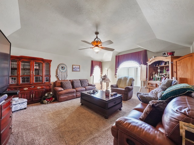 living room featuring a textured ceiling, light colored carpet, ceiling fan, and vaulted ceiling