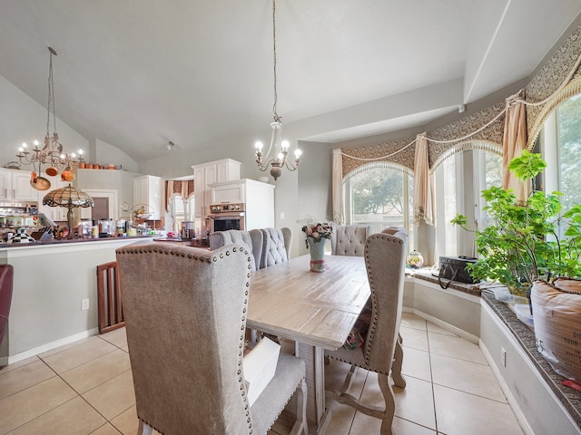 tiled dining space with vaulted ceiling and a notable chandelier