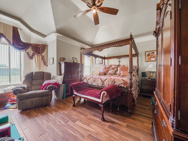 bedroom featuring lofted ceiling, crown molding, ceiling fan, and wood-type flooring