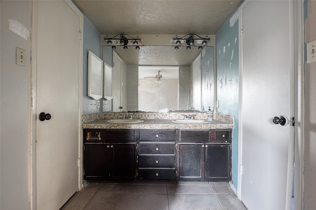 bathroom featuring tile patterned flooring, ceiling fan, a textured ceiling, and vanity