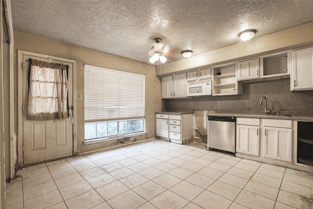 kitchen with a textured ceiling, dishwasher, sink, ceiling fan, and light tile patterned flooring