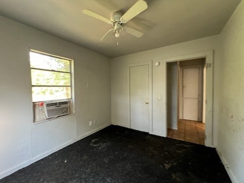 unfurnished bedroom with cooling unit and ceiling fan