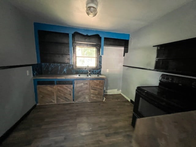 kitchen with black electric range oven, sink, and dark hardwood / wood-style floors