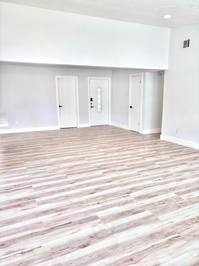 spare room with light hardwood / wood-style flooring