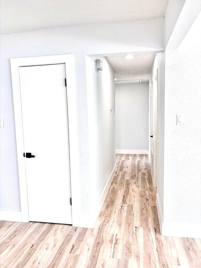 hall with light hardwood / wood-style floors