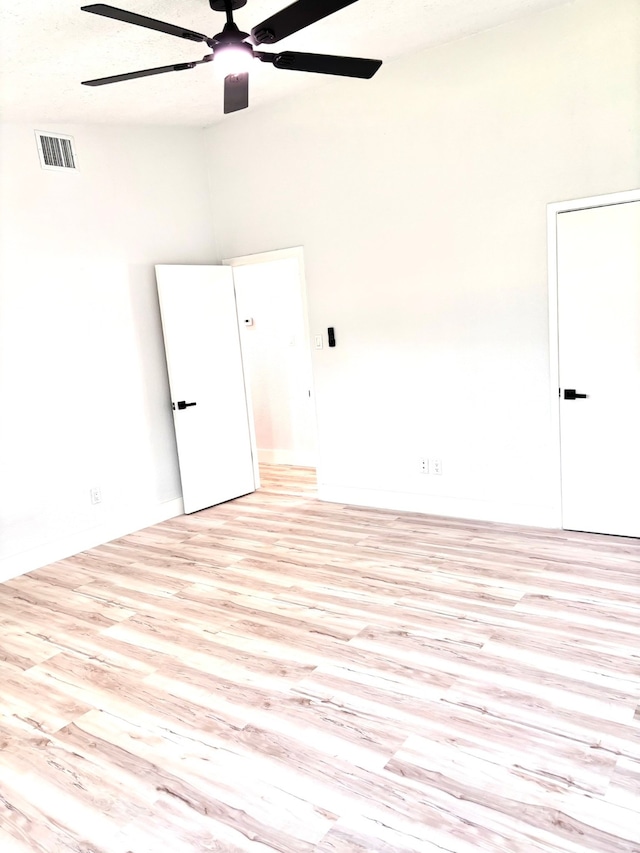 spare room featuring high vaulted ceiling, ceiling fan, and light hardwood / wood-style floors