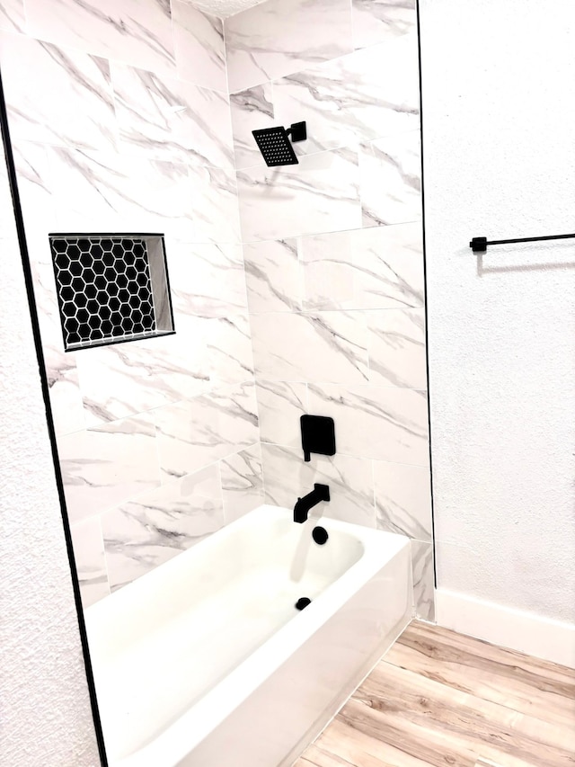 bathroom featuring tiled shower / bath and hardwood / wood-style floors