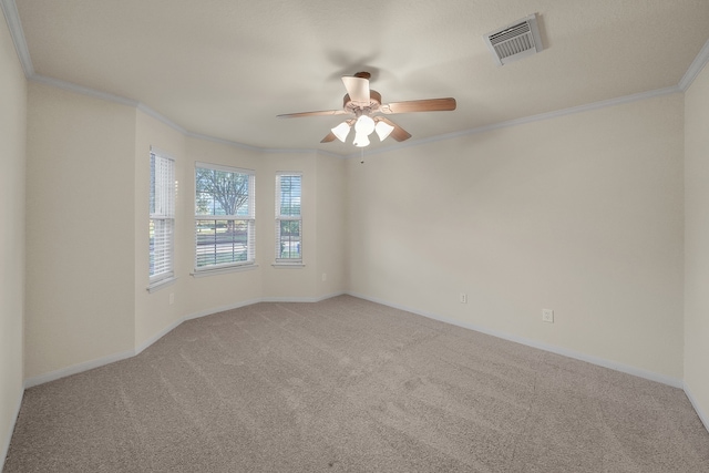 carpeted empty room with ceiling fan and crown molding