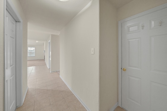 hallway featuring light tile patterned floors