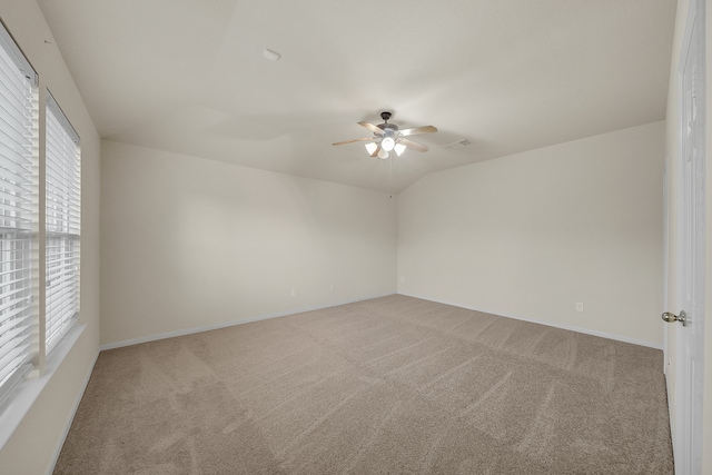 carpeted empty room with lofted ceiling and ceiling fan