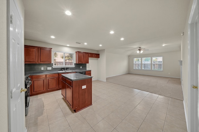 kitchen with ceiling fan, a center island, black / electric stove, and a healthy amount of sunlight