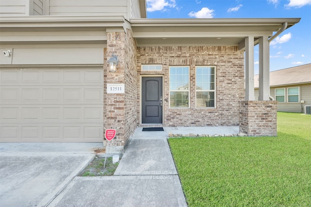 doorway to property featuring a garage and a yard