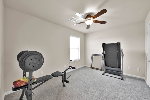 workout area featuring ceiling fan and light colored carpet