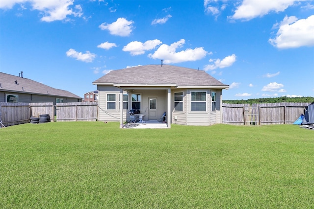 back of house featuring a yard and a patio