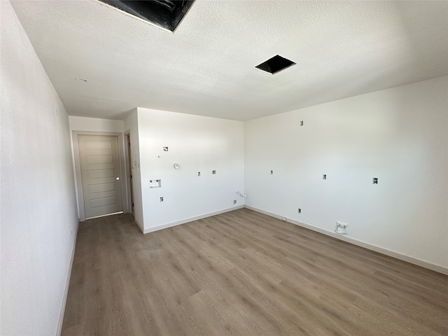 washroom featuring a textured ceiling and hardwood / wood-style flooring